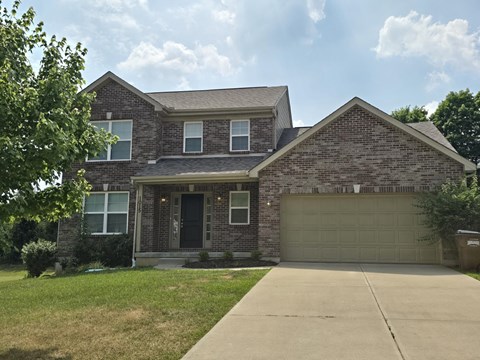 a house with a driveway and a garage door